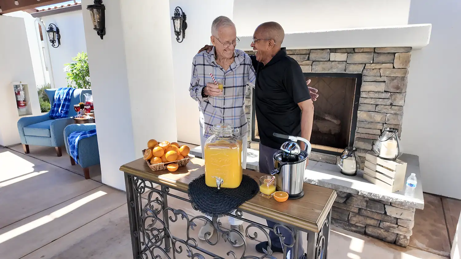 Residents enjoying outdoor refreshment area showcasing amenities of senior living community at Artesian of Ojai in Ojai California