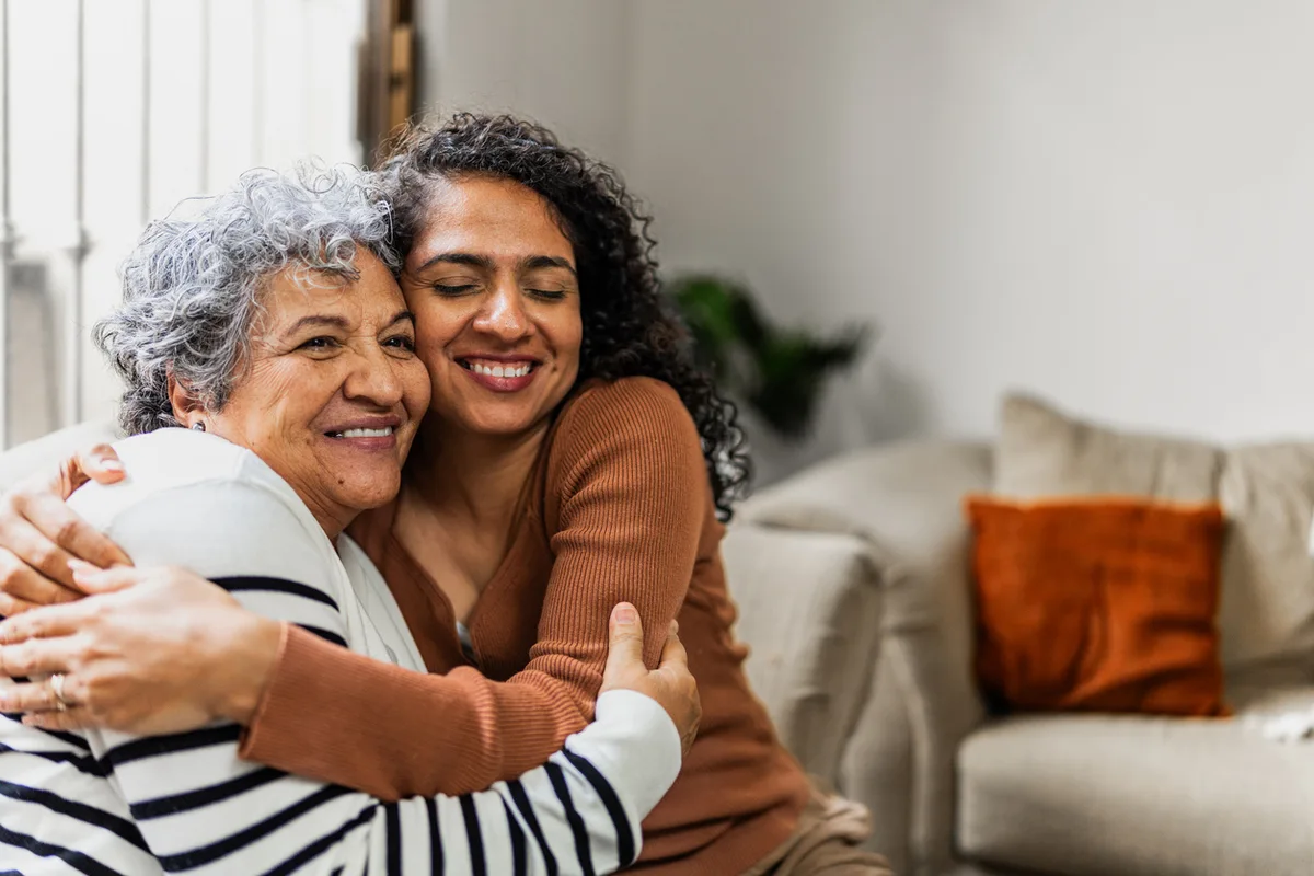 Assisted Living Facility Resident Hugging Daughter With Smile On Their Faces Assisted Living Facility Resident Hugging Daughter With Smile On Their Faces