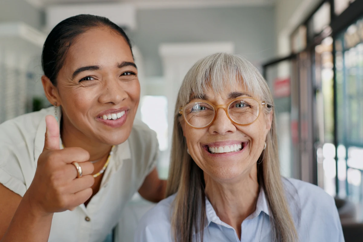 Smiling Madonna Gardens resident with caregiver in assisted living community in Salinas, CA