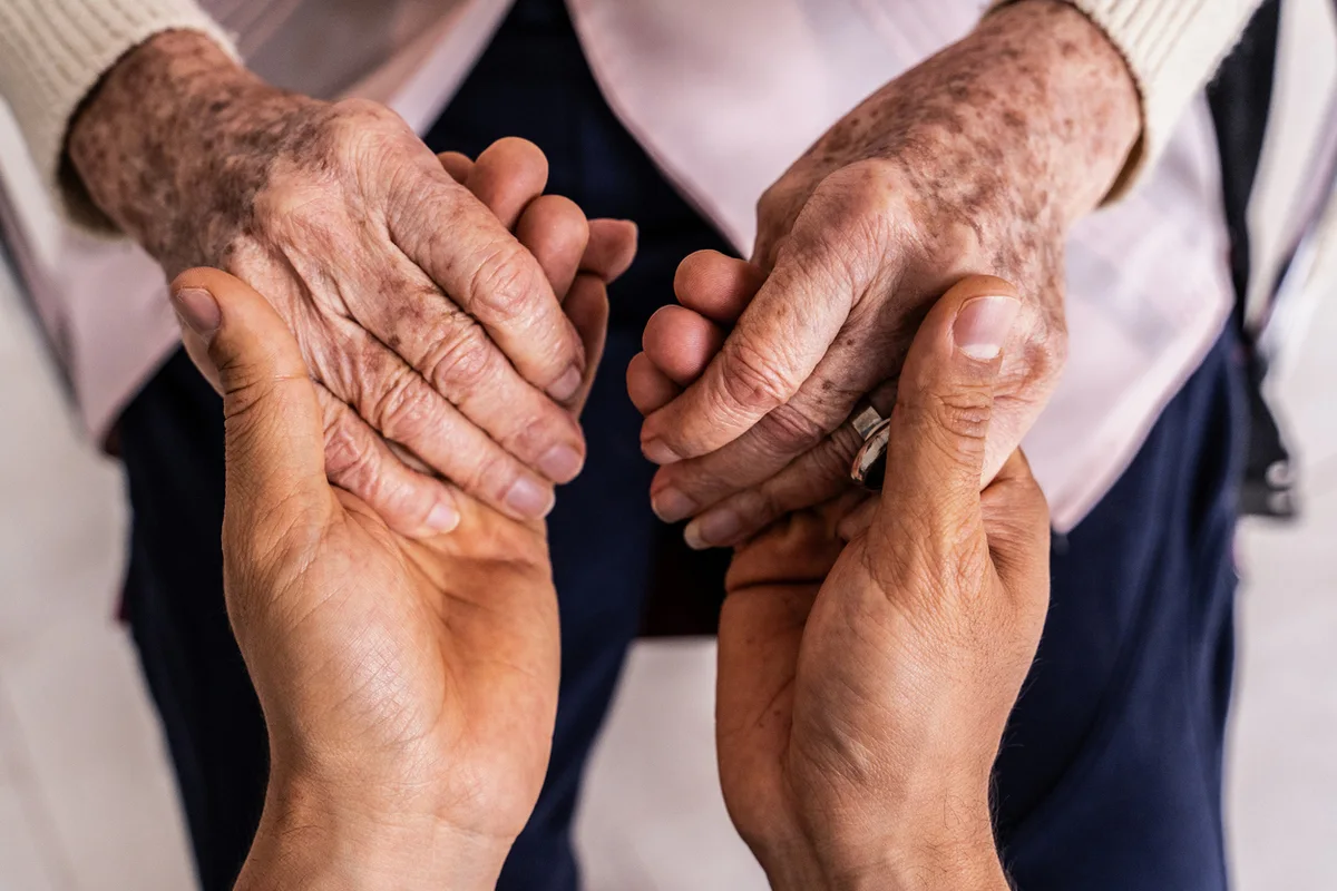 Senior receiving personal care assistance in assisted living