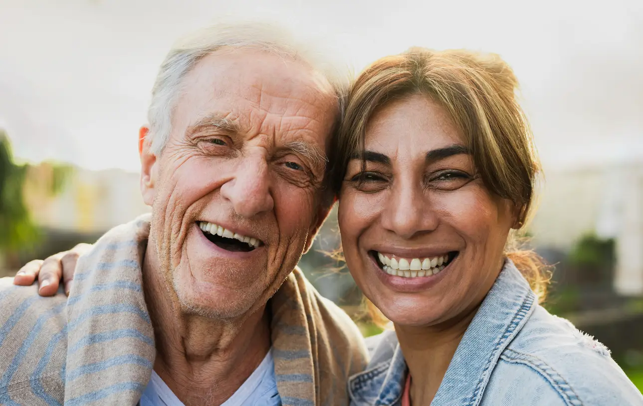 Senior resident and caregiver smiling together at Artesian of Ojai senior living community in Ojai California
