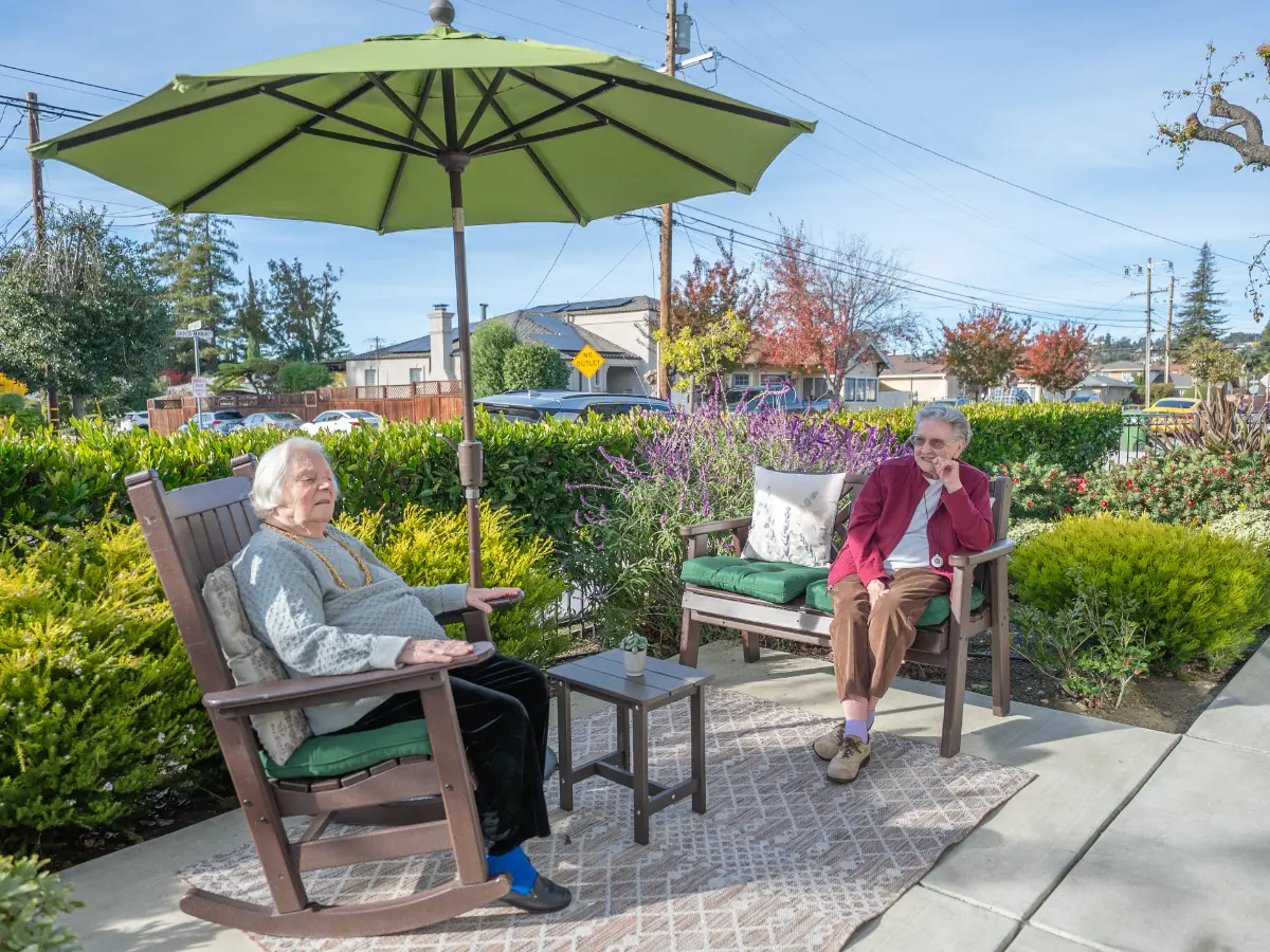 Residents relaxing outdoors in senior living assisted living memory care at Carefield Castro Valley