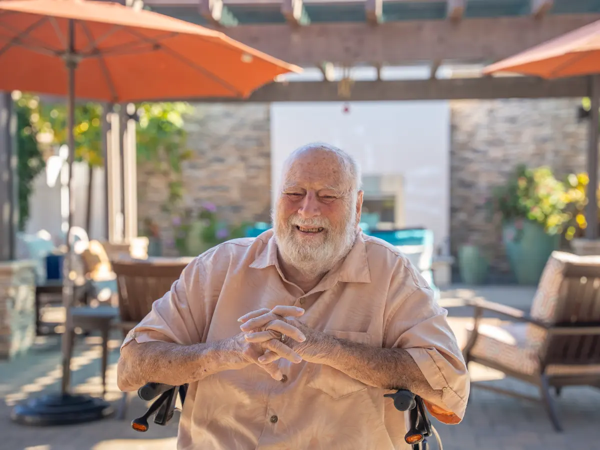 Smiling senior enjoying outdoor patio at Madonna Gardens senior living community in Dr Salinas CA offering assisted living and memory care