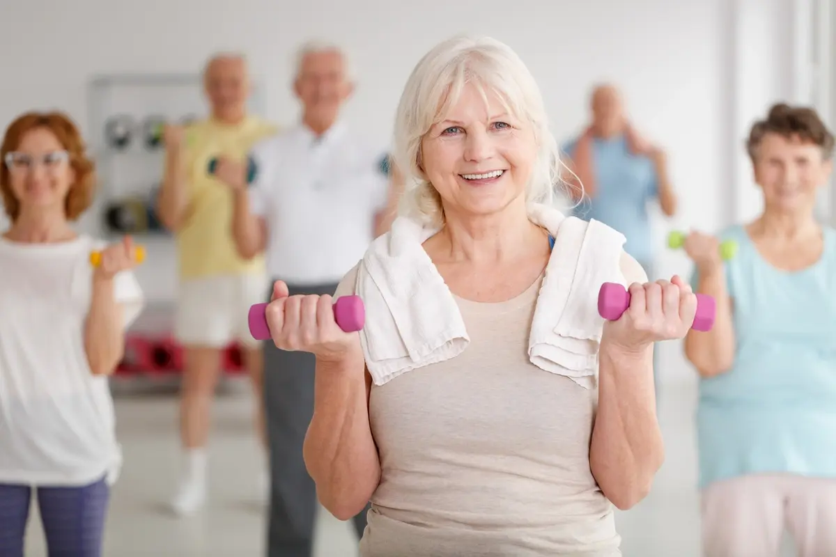 seniors-exercise-dumbbells-fitness-class Residents actively joining exercise programs for seniors at Carefield Castro Valley fitness class