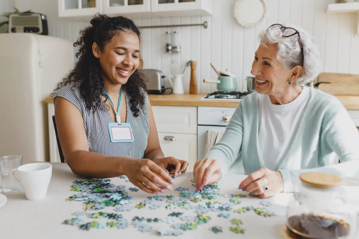 Senior woman smiling during a reminiscence therapy activity at an assisted living community in Ojai, CA