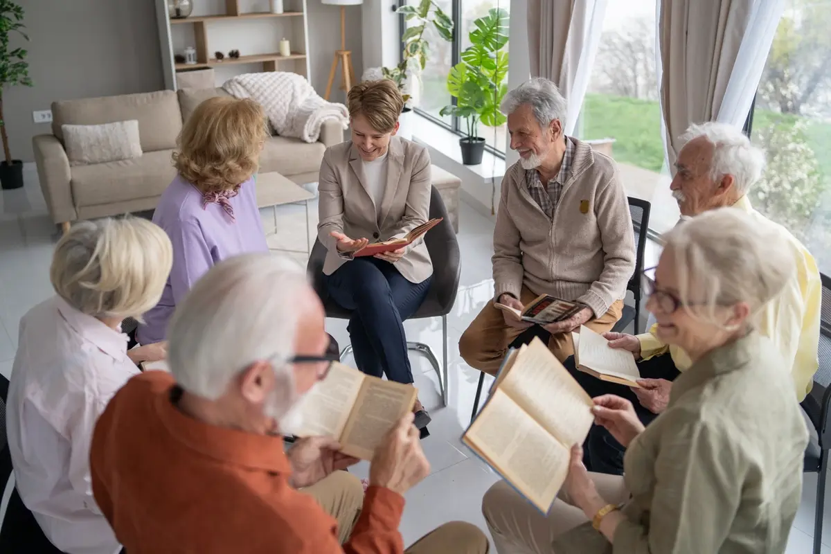 What Services Does Assisted Living Provide. Seniors in assisted living enjoying friendly conversation in a cozy community setting in Visalia CA