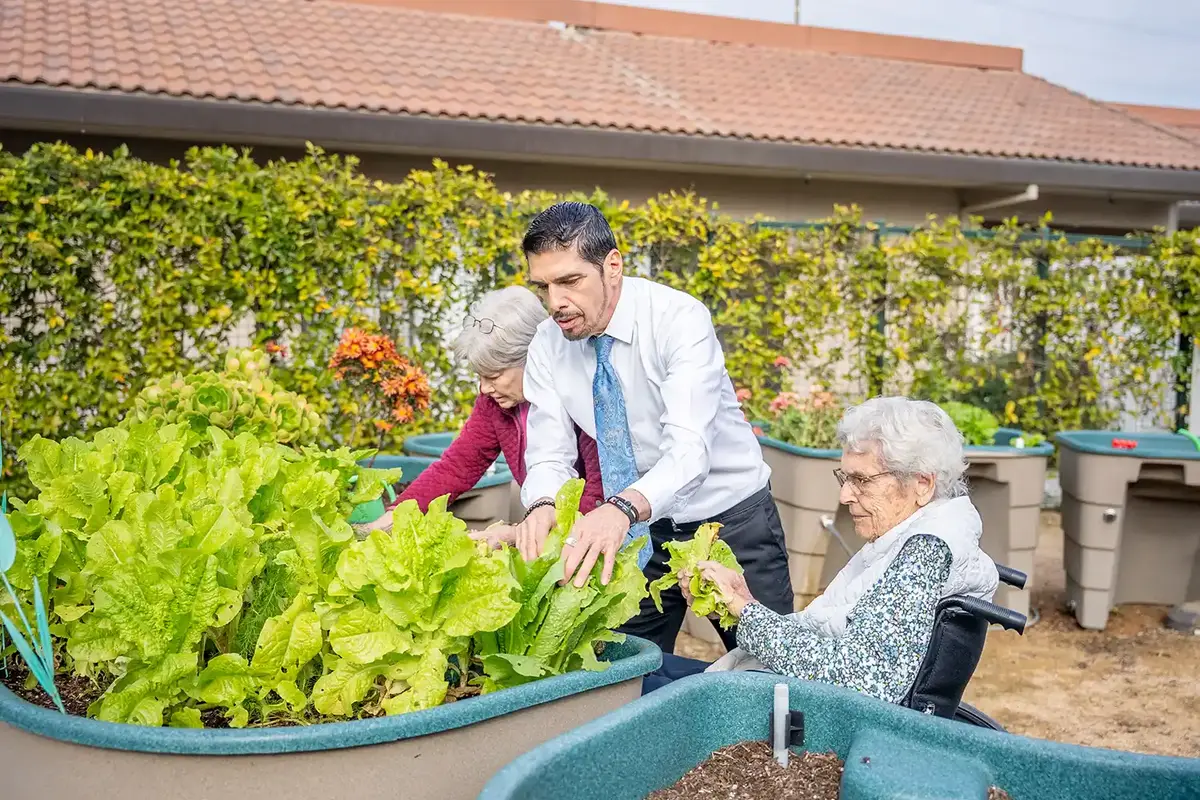 Resident participates in gardening therapy in senior living at Park Visalia
