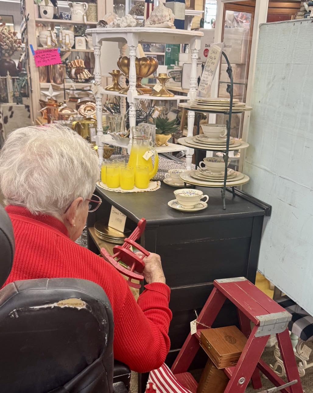 park visalia resident examining a vintage object during reminiscence therapy activities in an antique shop in Visalia